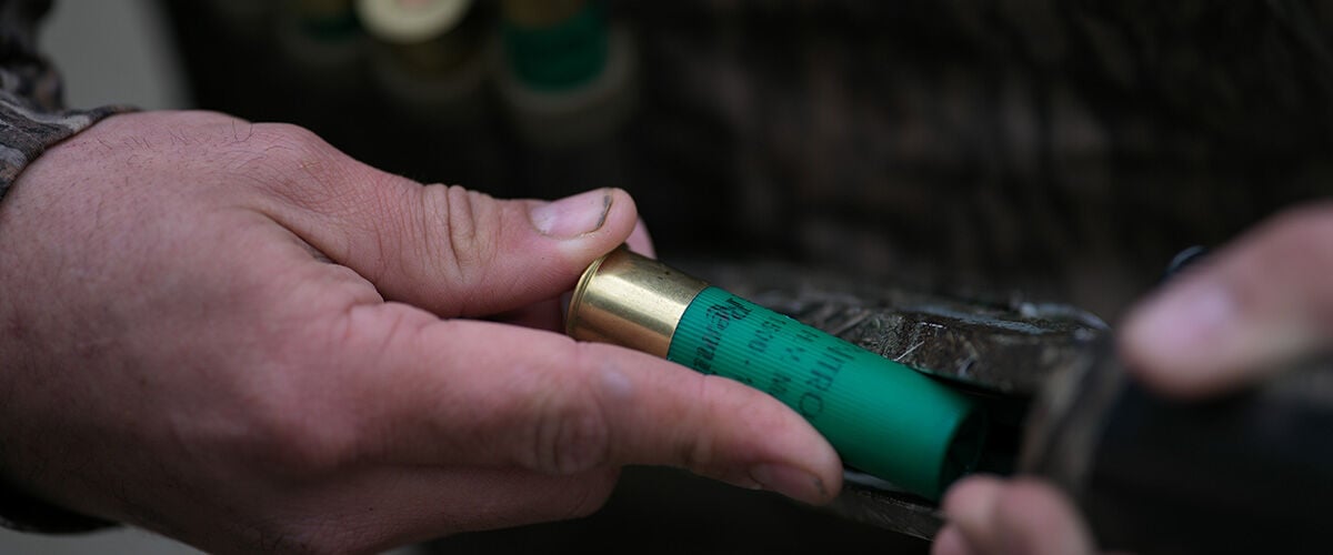 Man loading Nitro shotshell into shotgun